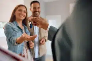 A couple getting the keys to their new home.